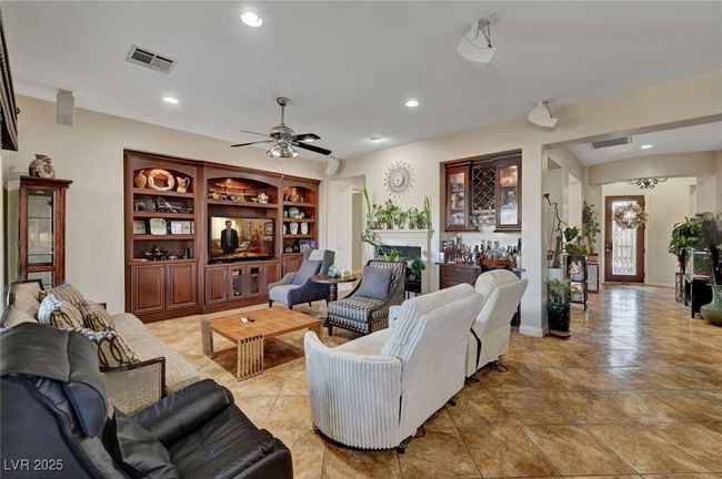 Living area with recessed lighting, a ceiling fan, a fireplace, and bar | Image 26