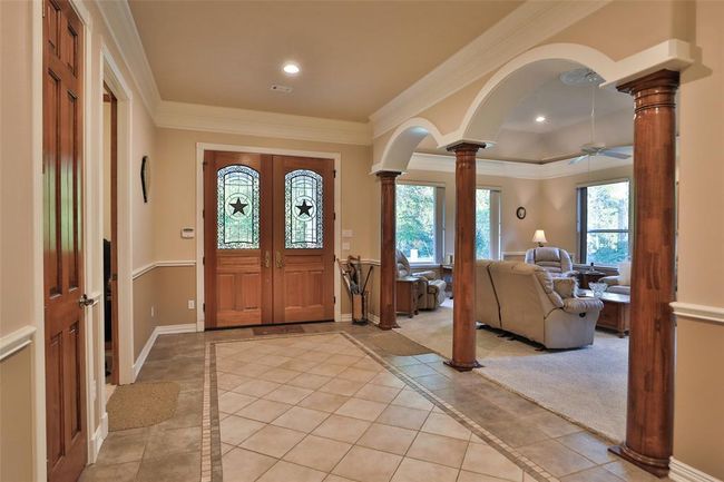 A view looking back at the front doors. The double doors include decorative windows with stars in the center. | Image 12