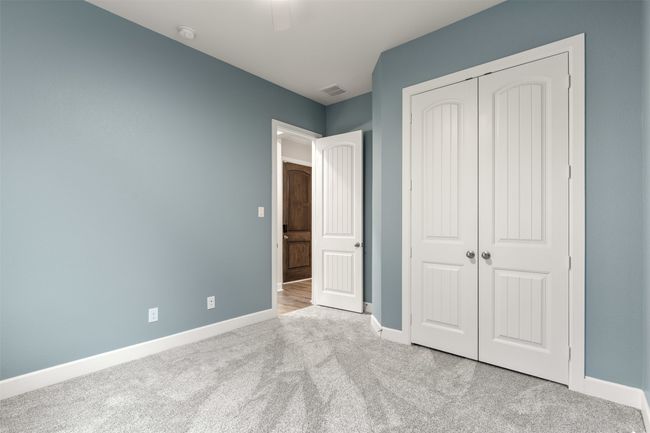 Unfurnished bedroom with carpet flooring, baseboards, a closet, and ceiling fan | Image 27