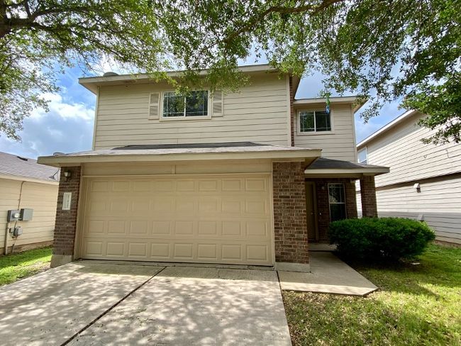 Traditional-style home with brick siding, an attached garage, and driveway | Image 7