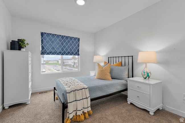 Bedroom featuring light colored carpet and baseboards | Image 11
