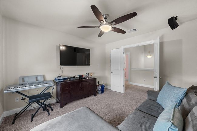 Carpeted Media room featuring ceiling fan and baseboards | Image 24