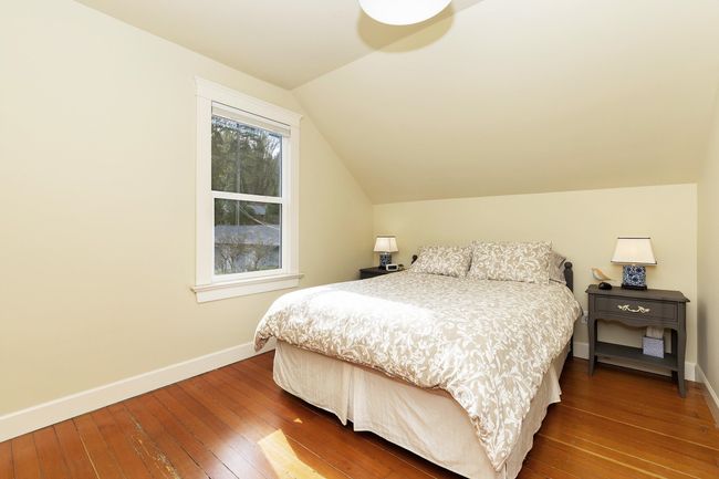 Bedroom featuring hardwood / wood-style flooring, baseboards, and vaulted ceiling | Image 15