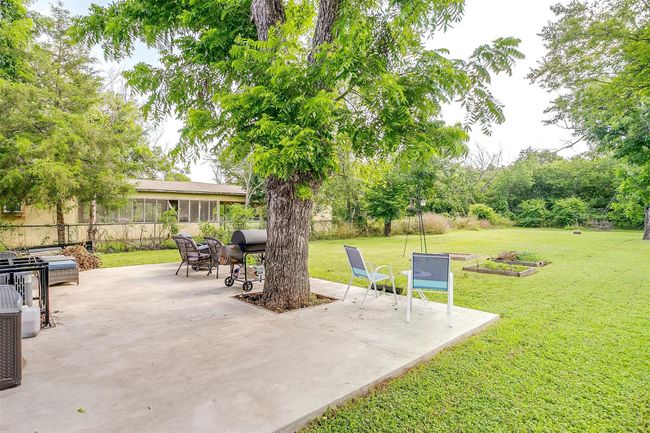Large concrete patio with area for grilling | Image 30