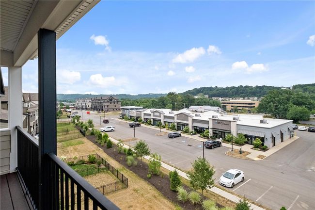 Third floor covered deck with recessed lights, ceiling fan, speakers and low maintenance floor and railing. Businesses close by provide much convenience. | Image 37