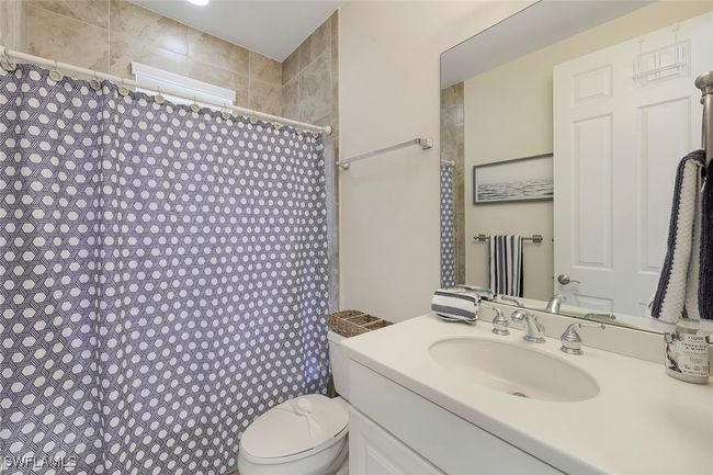 Bathroom featuring toilet, vanity, and walk in shower | Image 15