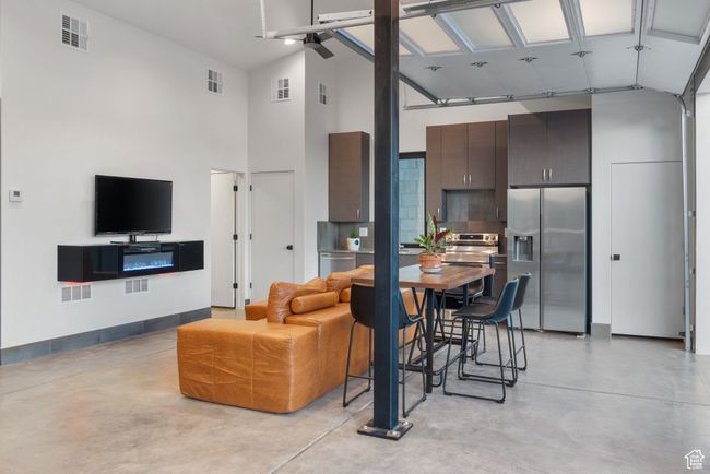 Living room with finished concrete floors and a towering ceiling | Image 74