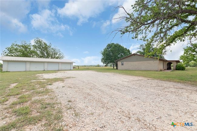 North side of ranch home with detached 4-bay garage/shop | Image 4