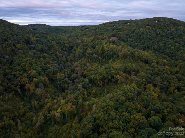This lot is in the top (right-ish) middle of this mountain picture (it's the lower left "dirt" area, you can see) - cleared and ready for your homesite - or pack a picnic and dream about what you want to do here! | Image 17