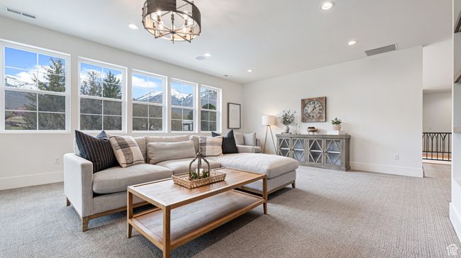 Carpeted living room with baseboards, a chandelier, visible vents, and recessed lighting | Image 42