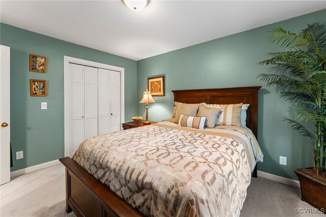 Bedroom with light carpet, baseboards, and a closet | Image 27
