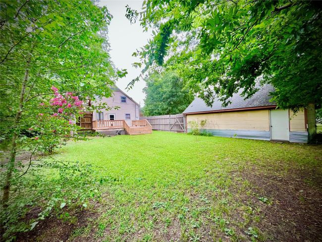 Fenced backyard with a wooden deck | Image 22