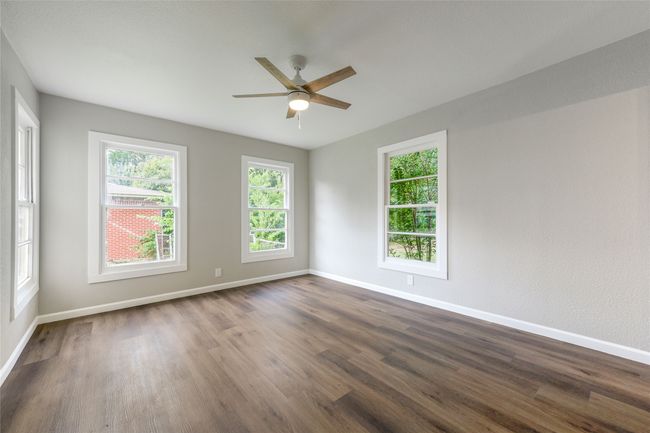Spare room featuring ceiling fan and dark wood-style flooring | Image 28