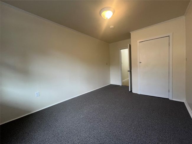 Empty room with dark carpet and baseboards | Image 11