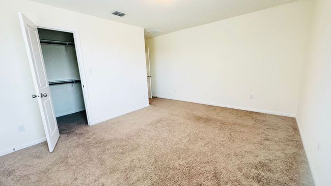 Unfurnished bedroom with carpet floors and a walk in closet | Image 30