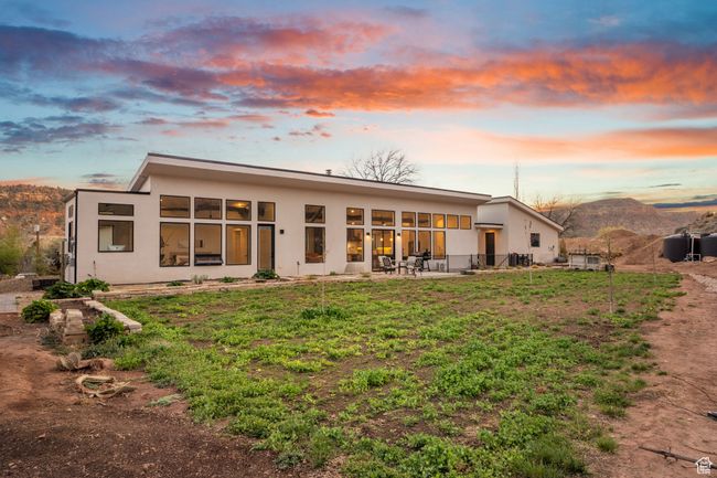 Back of property with a patio area, stucco siding, and a mountain view | Image 64
