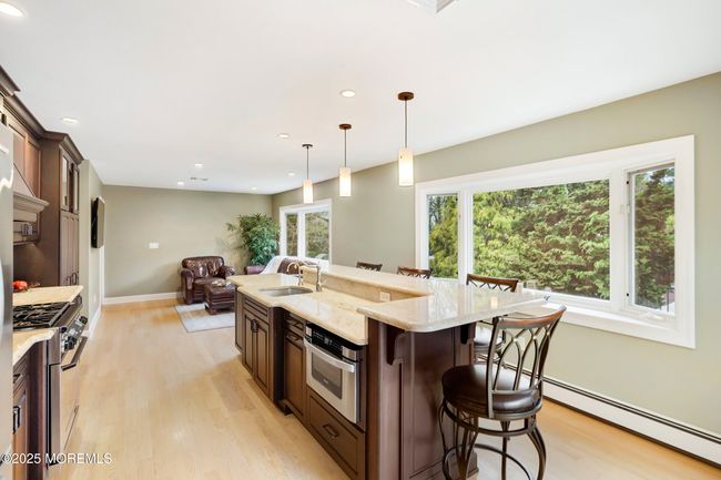 Kitchen with abundant light from large bay window | Image 16