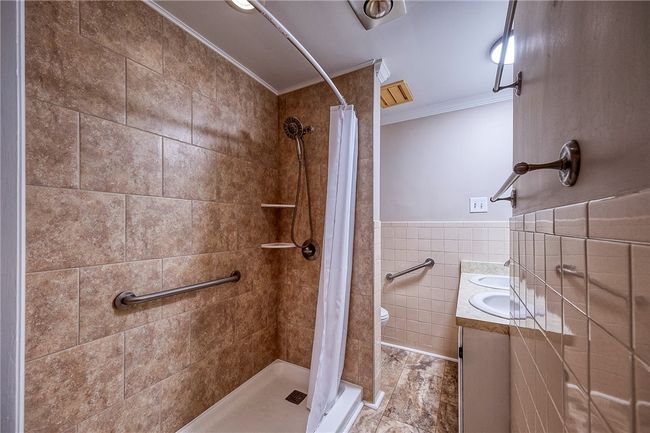 Main bathroom recently updated shower and flooring | Image 27