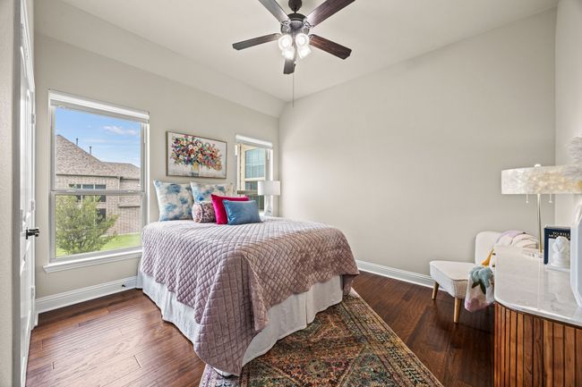 Bedroom featuring baseboards, wood flooring, and ceiling fan | Image 11