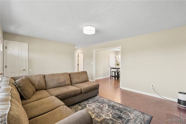 Living room featuring baseboards and wood finished floors | Image 13