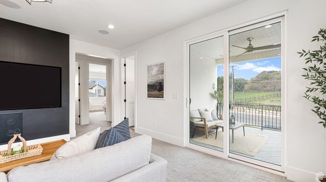 Carpeted living area with plenty of natural light, baseboards, and recessed lighting | Image 44