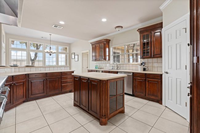 Full view of the kitchen showing the island, again, more storage and the pantry door to the right. The natural light in this home is abundant! | Image 19