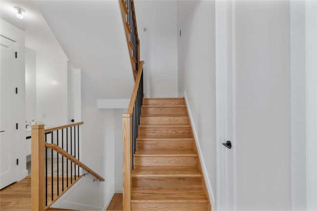 Staircase with baseboards and wood finished floors | Image 21