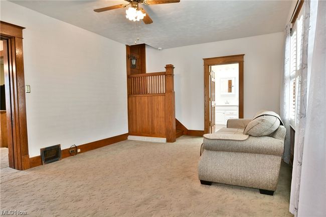 Unfurnished room featuring light carpet and ceiling fan | Image 10