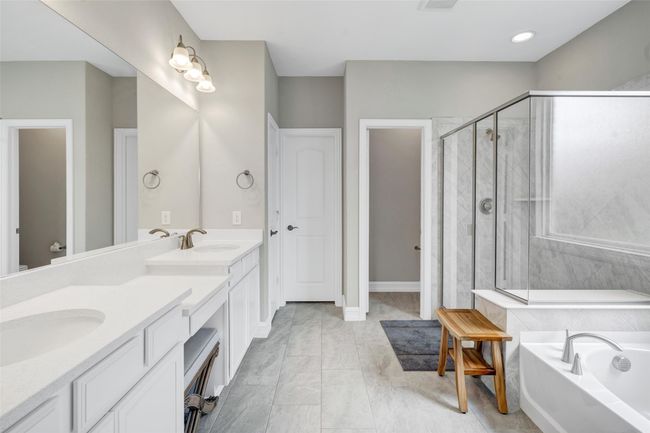 Primary bathroom features a vanity area and walk-in closet. | Image 22