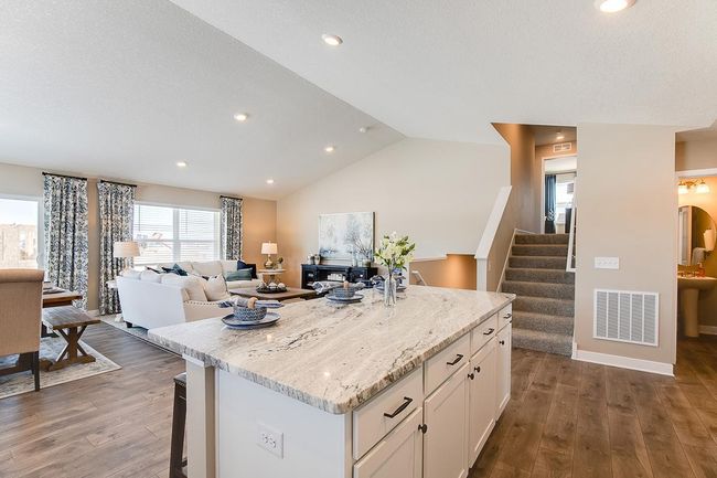 A view from the kitchen, you can see the open and interconnected main level. Model home photo, colors and selections may vary. | Image 4