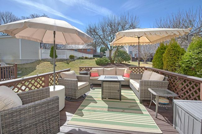 Wooden terrace featuring fence and an outdoor hangout area | Image 26