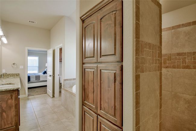 Ensuite bathroom with visible vents, a bath, connected bathroom, vanity, and tile patterned flooring | Image 21