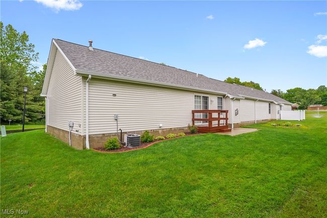 Back of property with a lawn, roof with shingles, and central AC unit | Image 25
