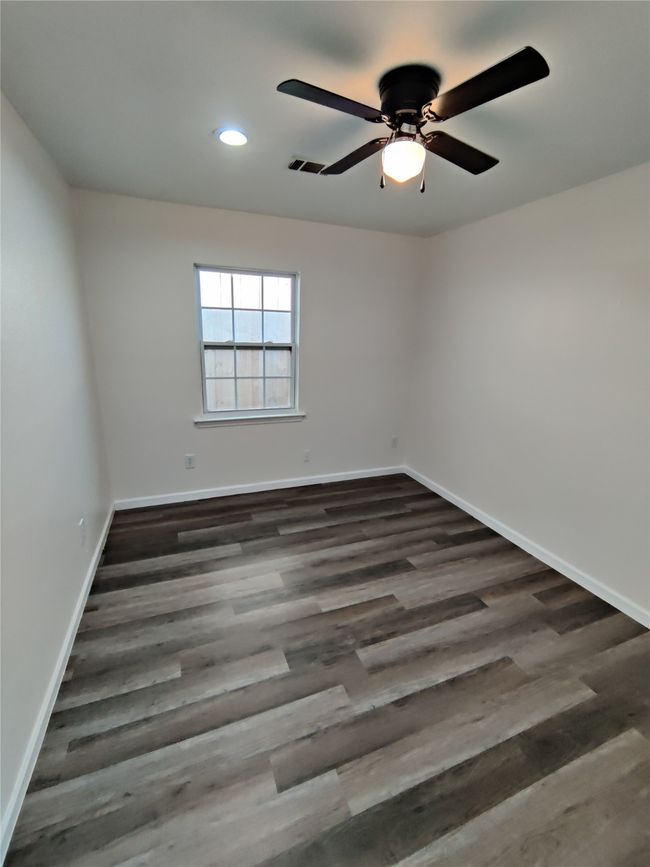 Unfurnished room with ceiling fan and wood-type flooring | Image 23