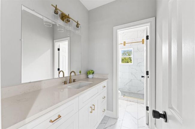 Full bathroom with modern fixtures and tile in shower. | Image 24