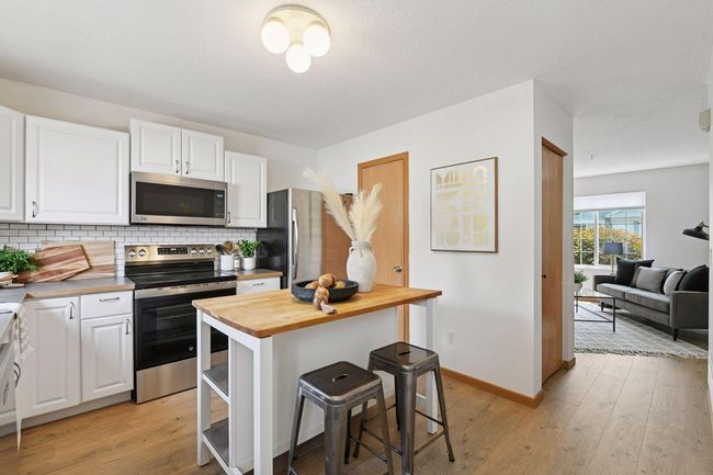 Kitchen with movable butcher block island and bar seating | Image 9