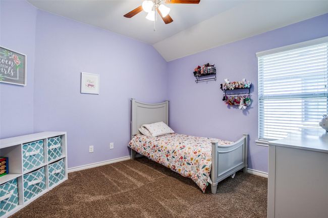 Bedroom with lofted ceiling, ceiling fan, and dark carpet | Image 18