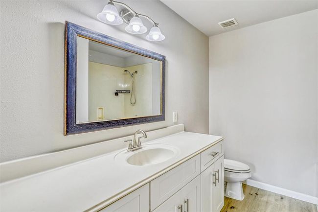 Welcome to your ensuite bathroom, featuring an updated vanity with shaker-style cabinets, modern finishes, and a framed mirror. You'll love the ample storage and clean, refreshed look. | Image 22