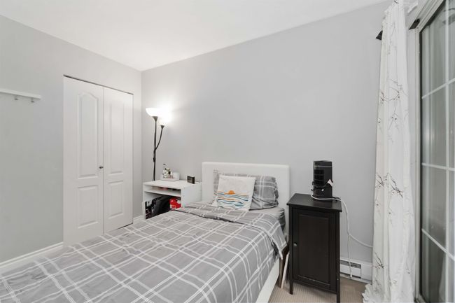 Bedroom featuring a closet, baseboards, and baseboard heating | Image 22
