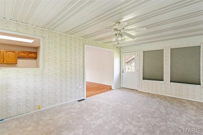 Unfurnished room with light carpet, wallpapered walls, ceiling fan, and baseboards | Image 11