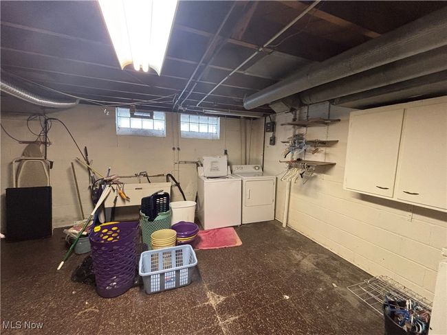 Basement with tile patterned floors and separate washer and dryer | Image 20