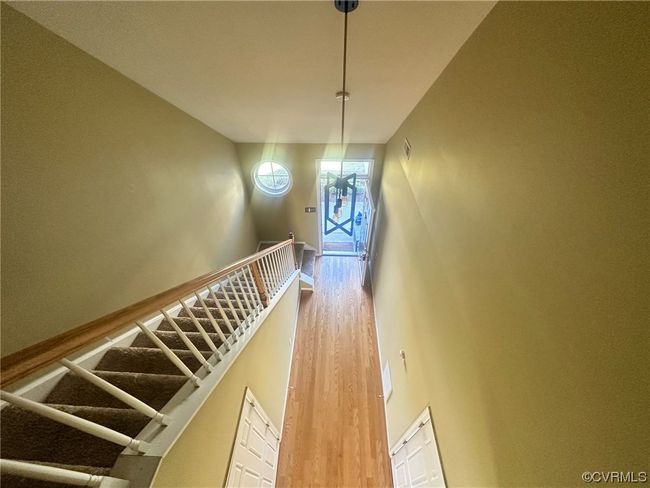 Stairway with hardwood / wood-style floors and a high ceiling | Image 7