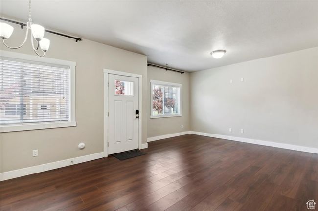 Foyer featuring a chandelier, dark wood finished floors, and baseboards | Image 5