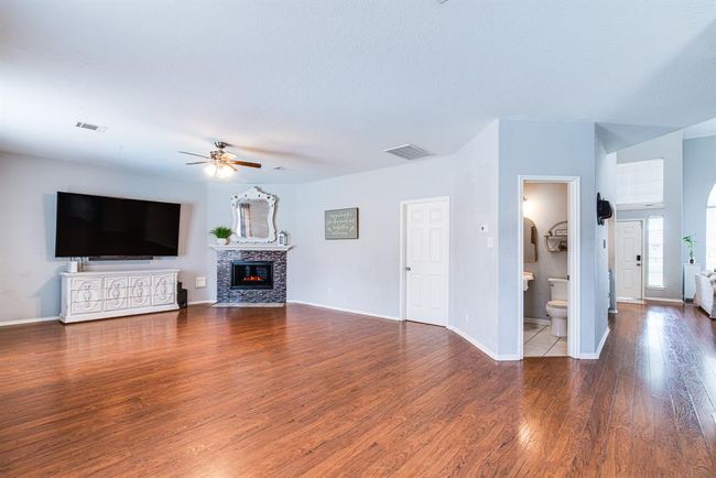 Large family room with access to downstairs powder-room | Image 12