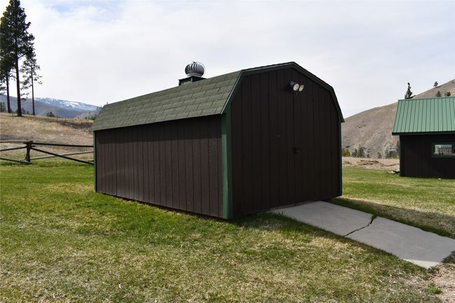 A 10' x 16' storage for lawn mower etc. Has concrete pad in front. | Image 42