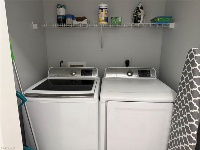 Laundry area with washing machine and clothes dryer | Image 18