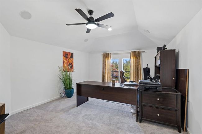 Versatile additional room, perfect for a study, game room, or whatever suits your needs. Large windows and an elevated ceiling enhance the spacious, open feel. | Image 32