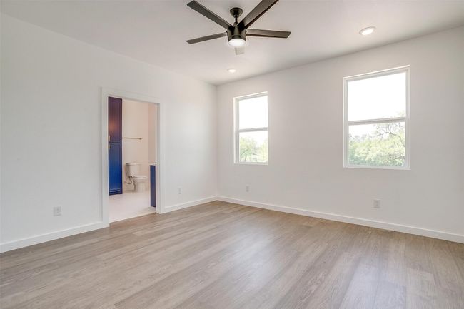 Spare room featuring ceiling fan, light wood-type flooring, and baseboards | Image 16