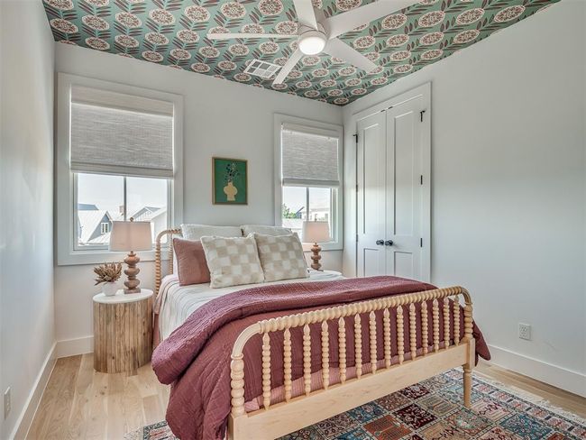 Bedroom with multiple windows, light wood-style flooring, a closet, and baseboards | Image 29