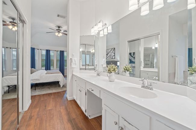 The primary ensuite bath is open to the bedroom with the option of closing it off with a sliding door or curtains. | Image 24